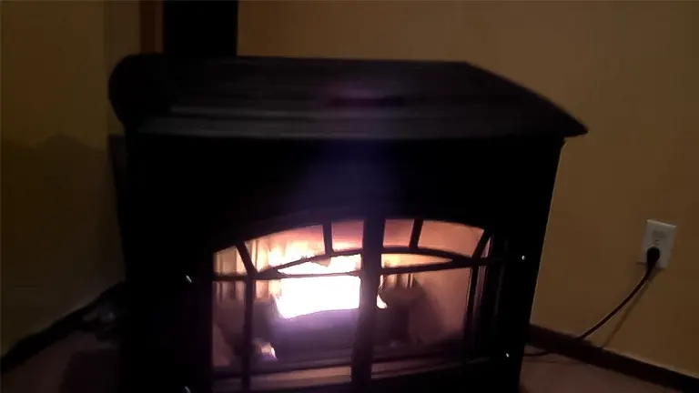 Black wood burning stove with a fire inside.