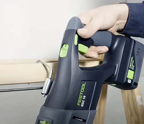 Person holding Festool Cordless Reciprocating Saw RSC 18 EB-Basic 576947 in a workshop
