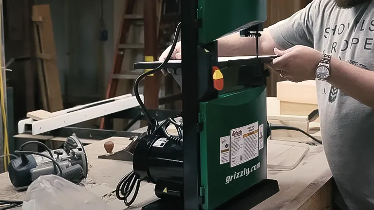 Person using a Grizzly bandsaw in a workshop.