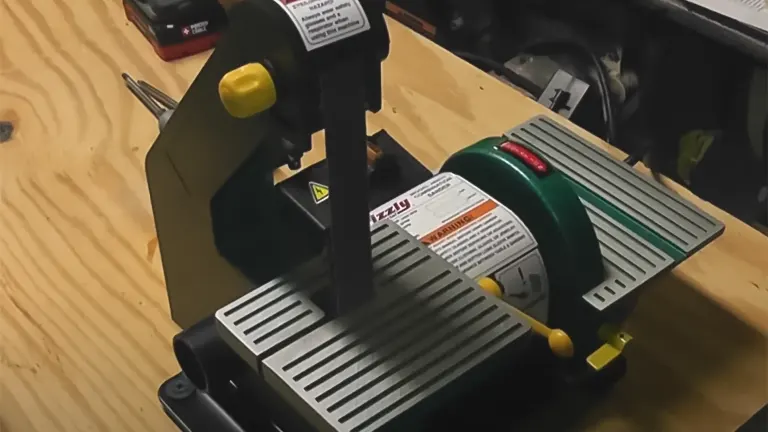 Grizzly H7760 Combo Belt Sander/Grinder on a wooden workbench with other tools in the background