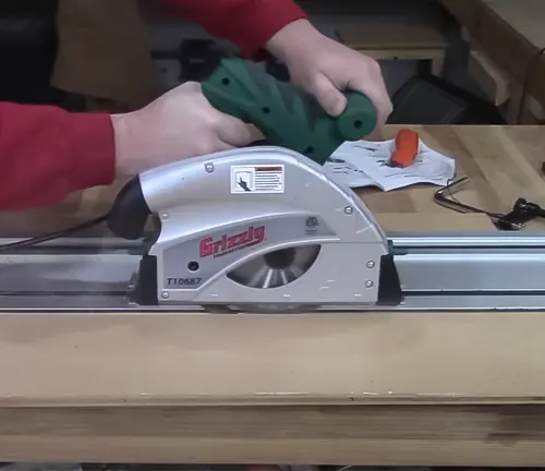 Person using a Grizzly T10687 miter saw on a wooden workbench.