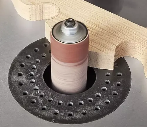 Close up of Grizzly T27417 Oscillating Edge Belt and Spindle Sander in use on a wooden board