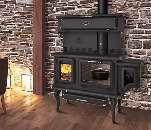 Black wood burning cook-stove with chimney in room with stone wall and wooden floor