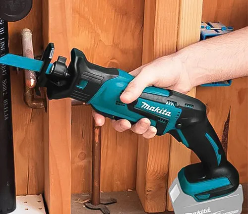 Makita DJR185Z Cordless Reciprocating Saw LXT 18V Li-Ion in use on wooden pipes
