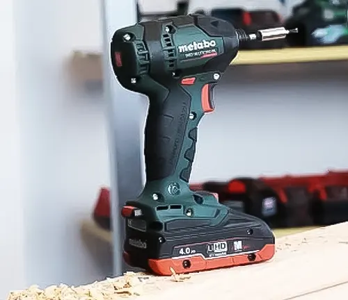 A Metabo 18V SSD LTX 200 BL cordless impact driver kit sitting on top of a piece of wood