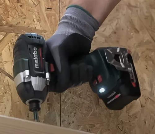 Hand using a Metabo 18V SSD LTX 200 BL Cordless Impact Driver on wood