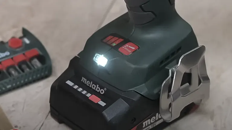 Metabo 18V SSD LTX 200 BL Cordless Impact Driver with drill bits on concrete
