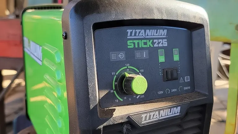Close-up of TITANIUM Stick 225 Inverter Welder with Electrode Holder on workbench.