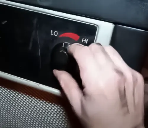 Hand adjusting temperature knob on US Stove B2350 Wonderluxe Coal Stove 