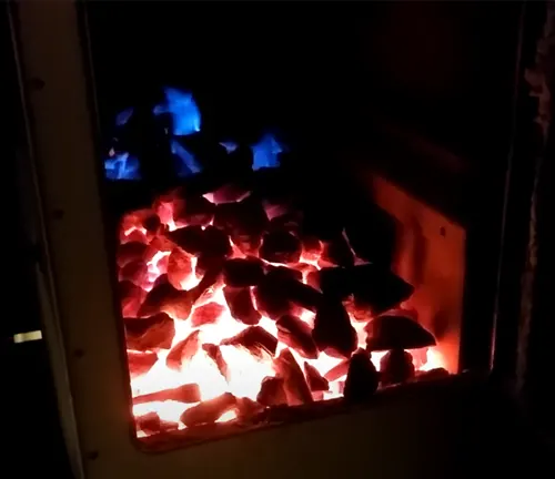 Close up of burning coals in furnace.
