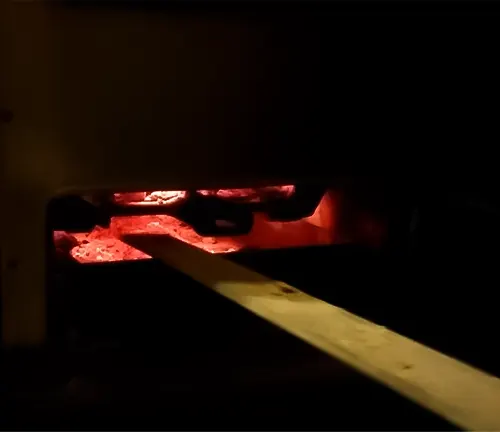 Dark room with red glow from furnace.