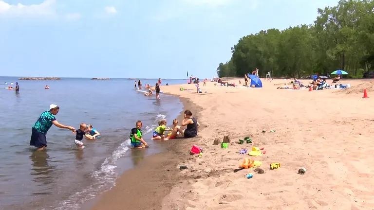 Families enjoying a sunny day at the beach in Presque Isle State Park