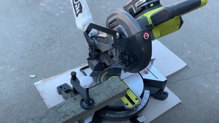 Black and green Ryobi P553 18V ONE+ 7-1/4” Compound Miter Saw on a concrete surface