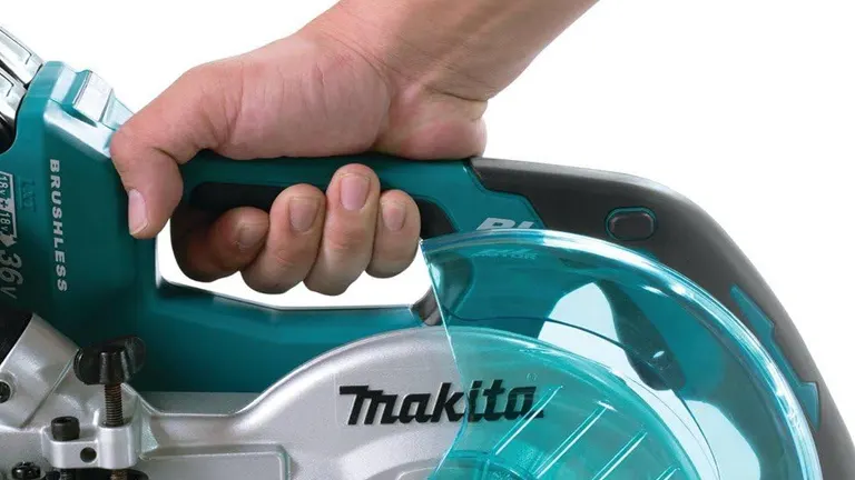 Close up of a hand holding a Makita 36V LXT Brushless 7-1/2" Dual Slide Compound Miter Saw