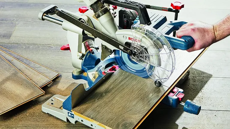 Person using a BOSCH GCM18V-07SN PROFACTOR 7-1/4” Single-Bevel Slide Miter Saw to cut wood in a workshop