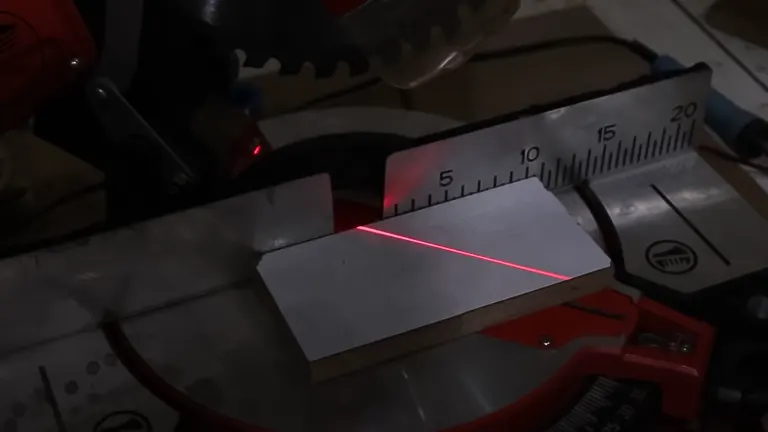 Miter saw with red laser guide line on wood, set for accurate cutting