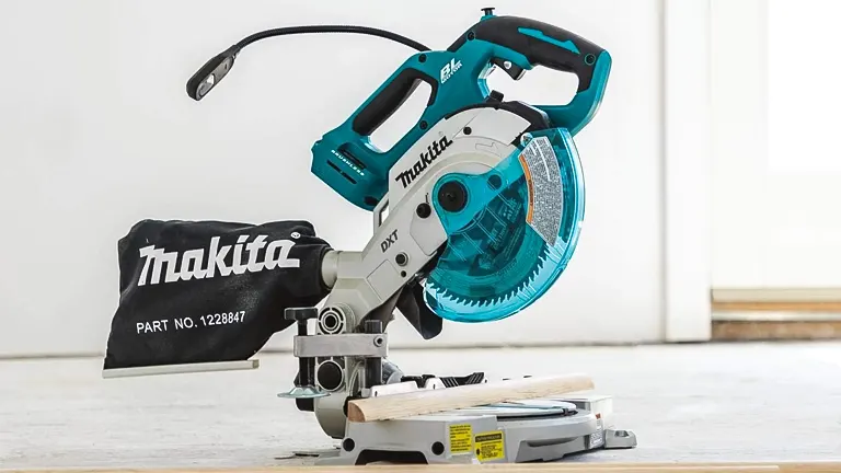 Compact Makita XSL05Z 18V LXT 6-1/2” Dual-Bevel Compound Miter Saw with Laser and dust bag on a white background