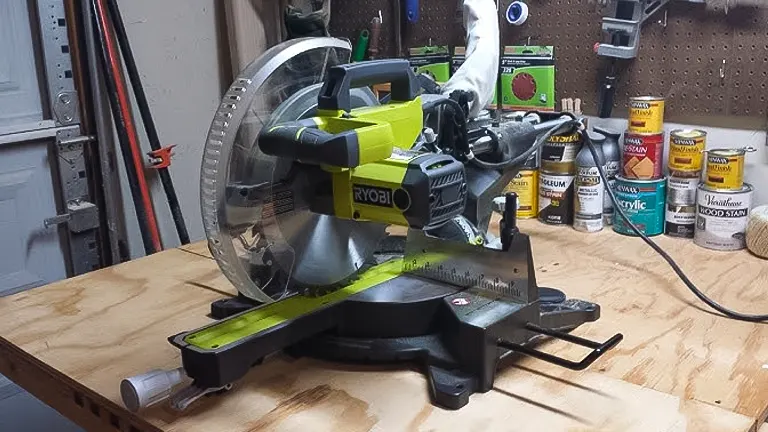 Ryobi 12” Sliding Compound Milter Saw on a workbench with tools in the background