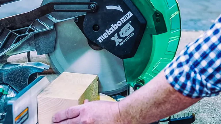 Person using a Metabo HPT C12FDHB 12” Dual-Bevel Compound Miter Saw to cut wood