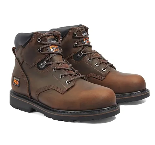 Pair of brown leather safety boots with black soles and orange labels, used as Personal Protective Equipment (PPE)