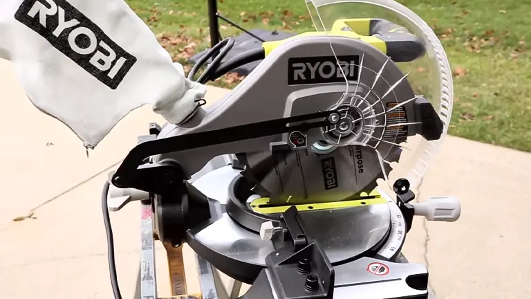 Ryobi 10-inch sliding compound miter saw with LED on a stand in a grassy area