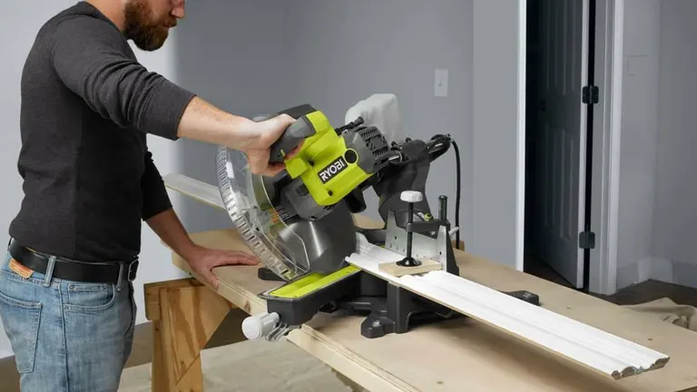 A person using a Ryobi 12” Sliding Compound Milter Saw on a wooden workbench