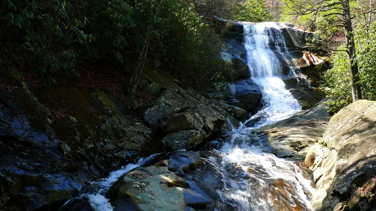 Cascading waterfall amidst rocks and greenery in Pisgah National Forest