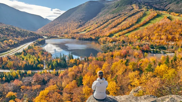 Person admiring autumn foliage at Franconia Notch State Park