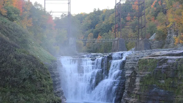 Autumnal waterfall at Letchworth State Park with a bridge in the background