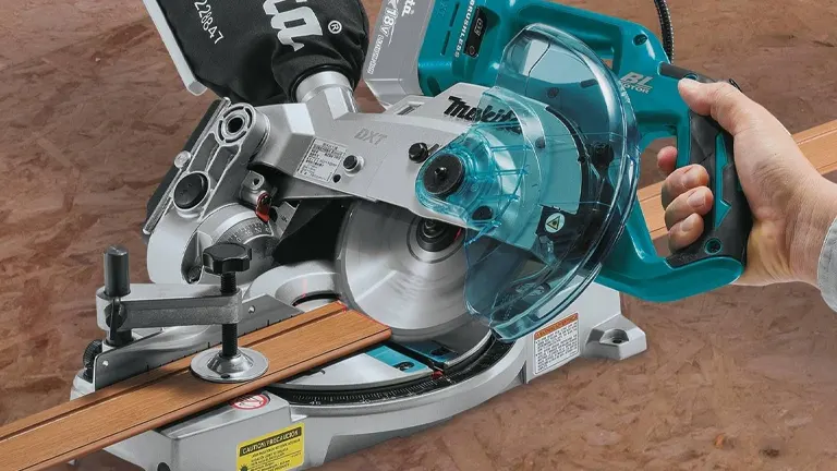 Makita 18V LXT 6-1/2” Compact Dual-Bevel Compound Miter Saw with Laser cutting a wooden board