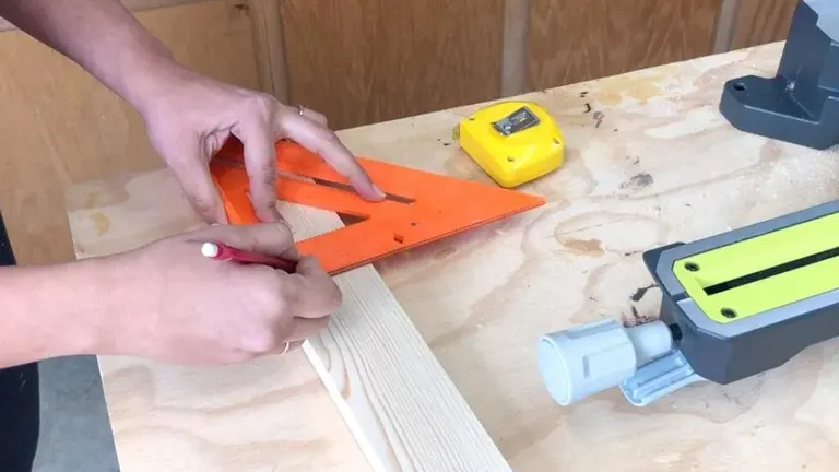 Person using miter saw with red pen and orange ruler for accurate wood cutting