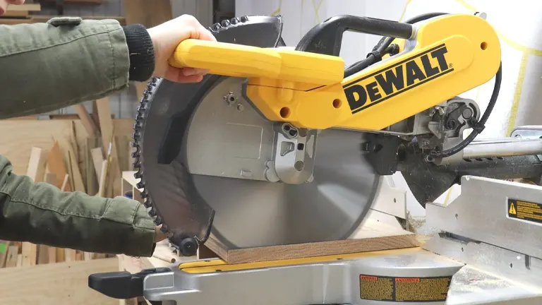 Person using a DeWalt miter saw in a workshop for accurate wood cutting
