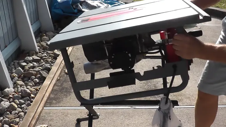 Person, visible from the waist down, adjusting a grey Craftsman 10-in Portable Table Saw with red accent outdoors