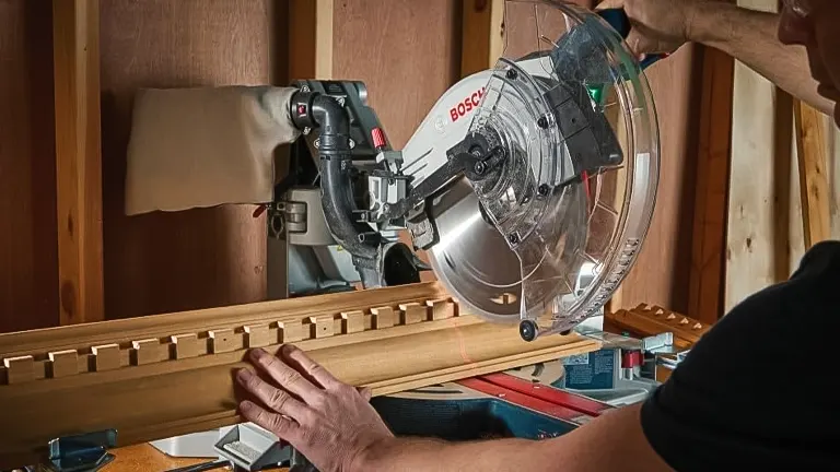 Person using a BOSCH PROFACTOR 18V 12” Dual-Bevel Sliding Miter Saw to cut wood