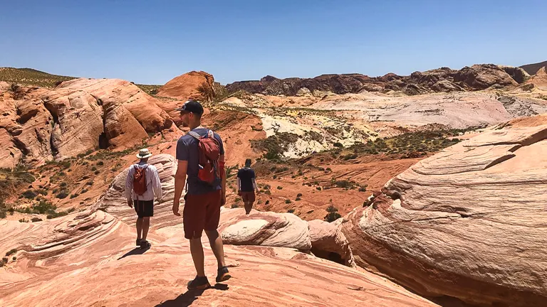 Hikers exploring the colorful and rugged terrain of Valley of Fire State Park