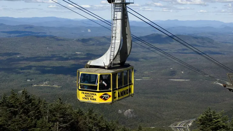 Yellow cable car suspended over Franconia Notch State Park