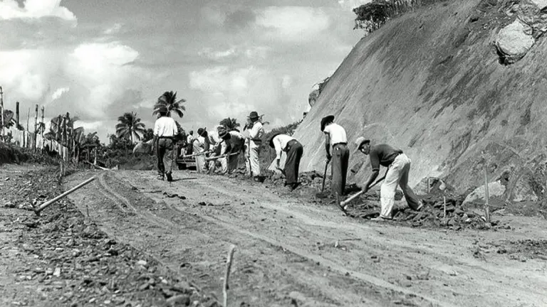 Workers constructing a road in a rural setting