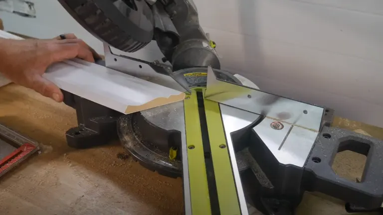 A Ryobi PBT01B ONE+ 18V 7-1/4” Sliding Compound Miter Saw in use on a wooden board