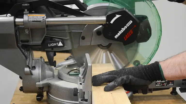 A Metabo HPT C10FSHCT 10" Dual-Bevel Sliding Compound Miter Saw with Laser in use on a wooden board