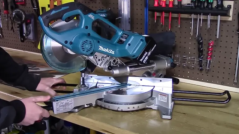 Makita 36V LXT Brushless 7-1/2" Dual Slide Compound Miter Saw on a workbench with tools in the background