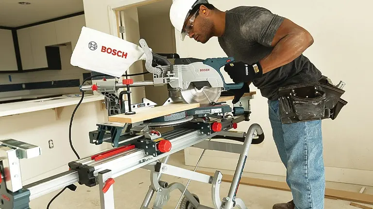 Person using a Bosch CM8S 8-1/2” Single Bevel Sliding Compound Miter Saw at a construction site