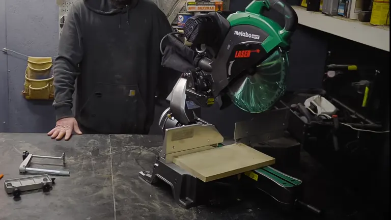 Metabo HPT C12RSH2S 12” Dual-Bevel Sliding Compound Miter Saw with Laser Marker on a black workbench in a workshop
