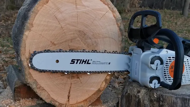 Stihl MS 151 TC E Chainsaw resting on a freshly cut log
