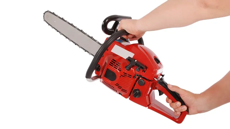 Hands demonstrating the correct grip and stance for holding a chainsaw