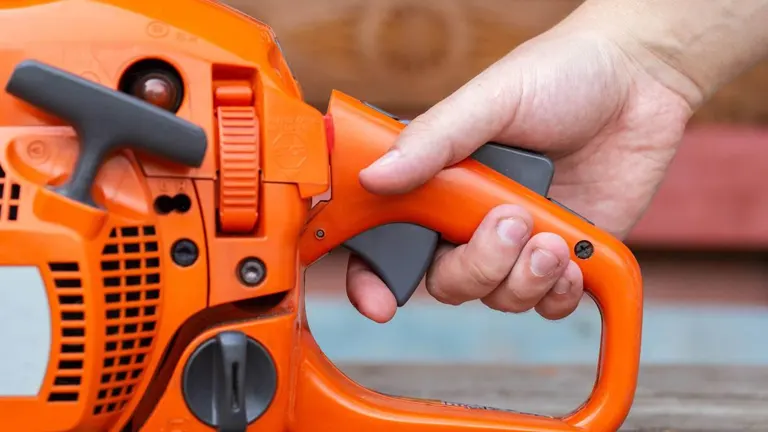 Hand adjusting the throttle control on an orange power tool