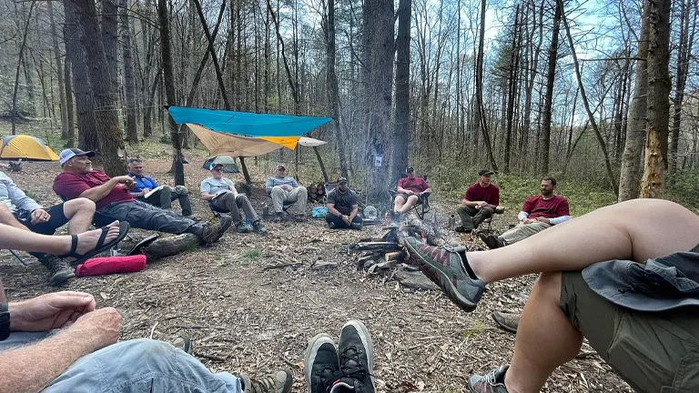 group of people gathered around a campfire in Pisgah National Forest