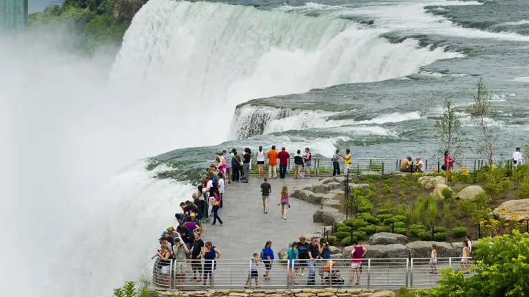 Visitors at Niagara Falls State Park observing the majestic waterfall