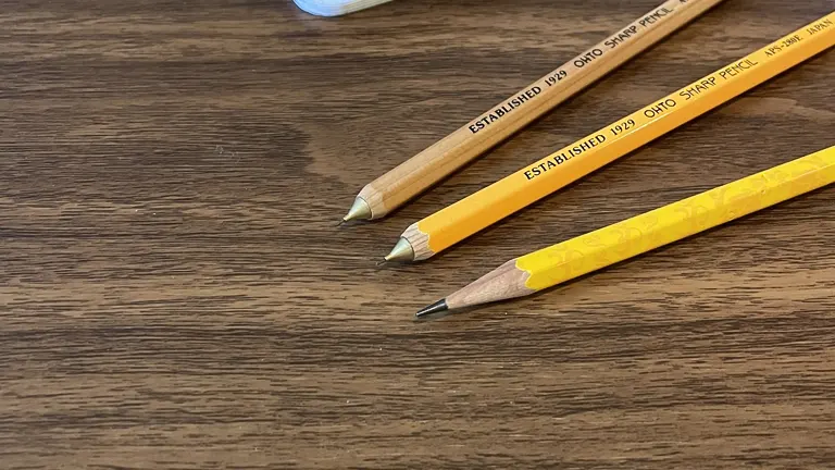 Three ‘Established 1817 Ohio Pencil Co.’ pencils on wooden surface for marking cuts
