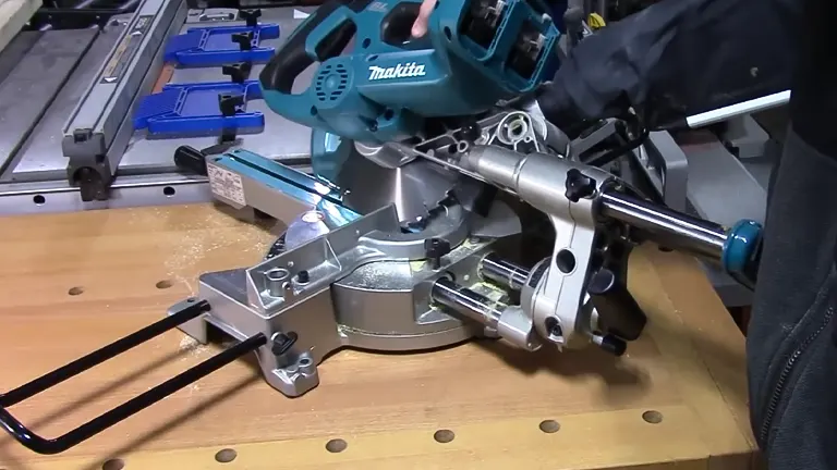 Makita 36V LXT Brushless 7-1/2" Dual Slide Compound Miter Saw cutting wood on a workbench