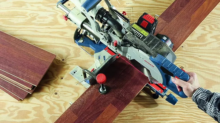 Person using a BOSCH GCM18V-08N 8-1/2" Single-Bevel Slide Miter Saw to cut a wooden plank